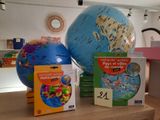 a globe, a book, and a dvd on a table