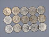 a bunch of silver coins sitting on top of a table