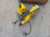 a yellow pipe and a rusty pipe on the ground