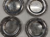 four silver plate dishes on a table with a white background