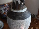 a vase that is sitting on a table next to a lamp