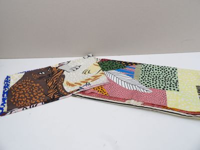 a pair of ties that are on a white table