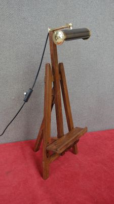 a wooden stand with a lamp on top of it