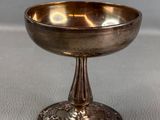 an image of a silver bowl sitting on top of a table