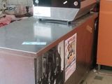an image of a kitchen with a refrigerator and a microwave