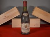 a bottle of wine sitting on a table next to two wooden boxes