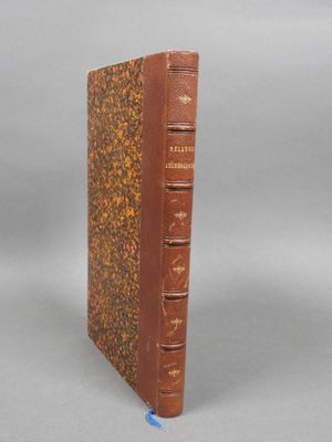 an old book sitting on top of a table next to a gray background
