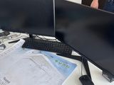two monitors on a desk with a keyboard and a mouse