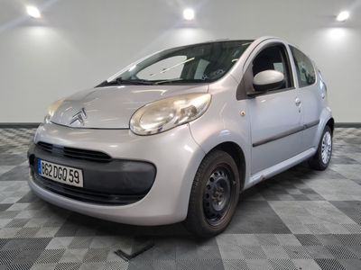 a picture of a small silver car parked in a garage