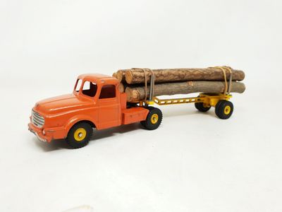 a toy truck with a log on the back of it