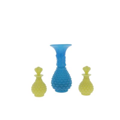 three vases sitting next to each other on a white surface