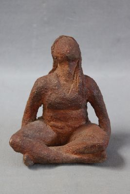 statue of a woman sitting in a yoga position