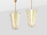 pair of gold plated metal and glass earrings on a white background