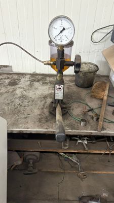 pipes and gauges are sitting on a table in a room