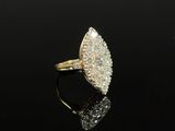 a gold and diamond ring on a black surface