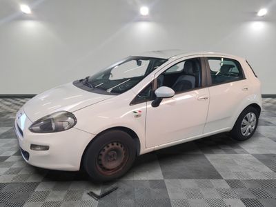 a picture of a small white car parked in a garage