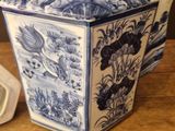 a blue and white teapot sitting on a wooden table