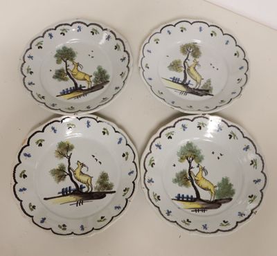four plates with a picture of a giraffe and a bird on them