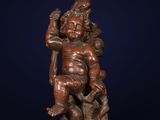 a bronze statue of a man holding a child on his back