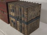 several old books are stacked on top of each other on a table