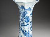 blue and white porcelain vase with a landscape scene on it