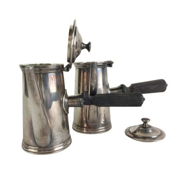 a silver coffee pot with a gun on it