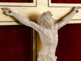 a statue of jesus on the cross on the wall
