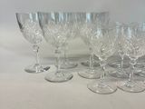 six wine glasses are lined up in a row on a table