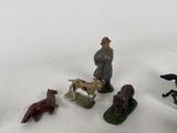 five figurines of people and animals in the snow