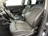the interior of a car with a black leather seat and steering wheel