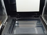 a black printer with a white screen sitting on top of it