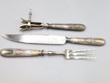 three knives and a knife sharper on a table