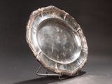 a silver plate sitting on a stand on a table