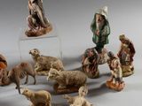 many figurines of people and animals on a table