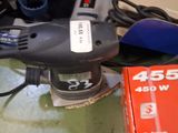 a picture of a corded sander and a box of power tools