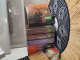 a lot of books and a fan sitting on a table