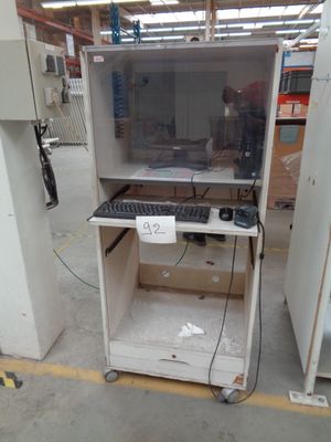 a computer on a cart in a warehouse with a lot of tools