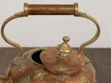 a tea kettle that is sitting on a wooden table