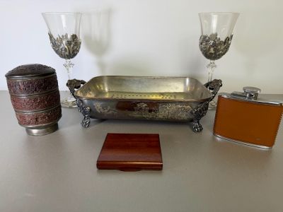 a silver tray and two wine glasses on a table