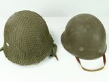 two helmets are sitting next to each other on a white surface