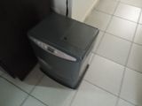 an image of a small computer on the floor of a kitchen