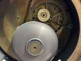 a close up of a clock that is on a table
