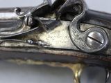 a close up of a gun on a white surface