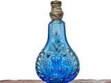 a blue glass bottle sitting on top of a table