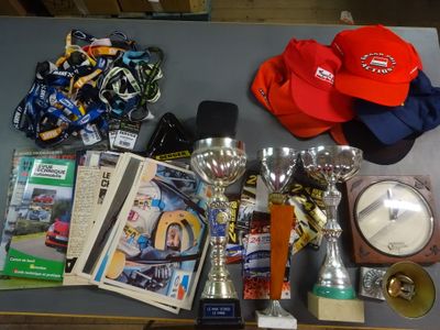a table with a lot of trophies and a hat on it