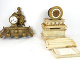 two clocks sitting on top of a stack of books