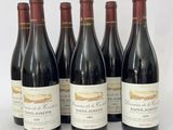 six bouteilles de vin sont alignées sur une surface blanche