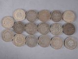several different types of coins are arranged in a row on a white surface