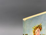 a book with a picture of a woman with flowers on her head