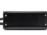 a black leather belt bag with a metal buckle on the side